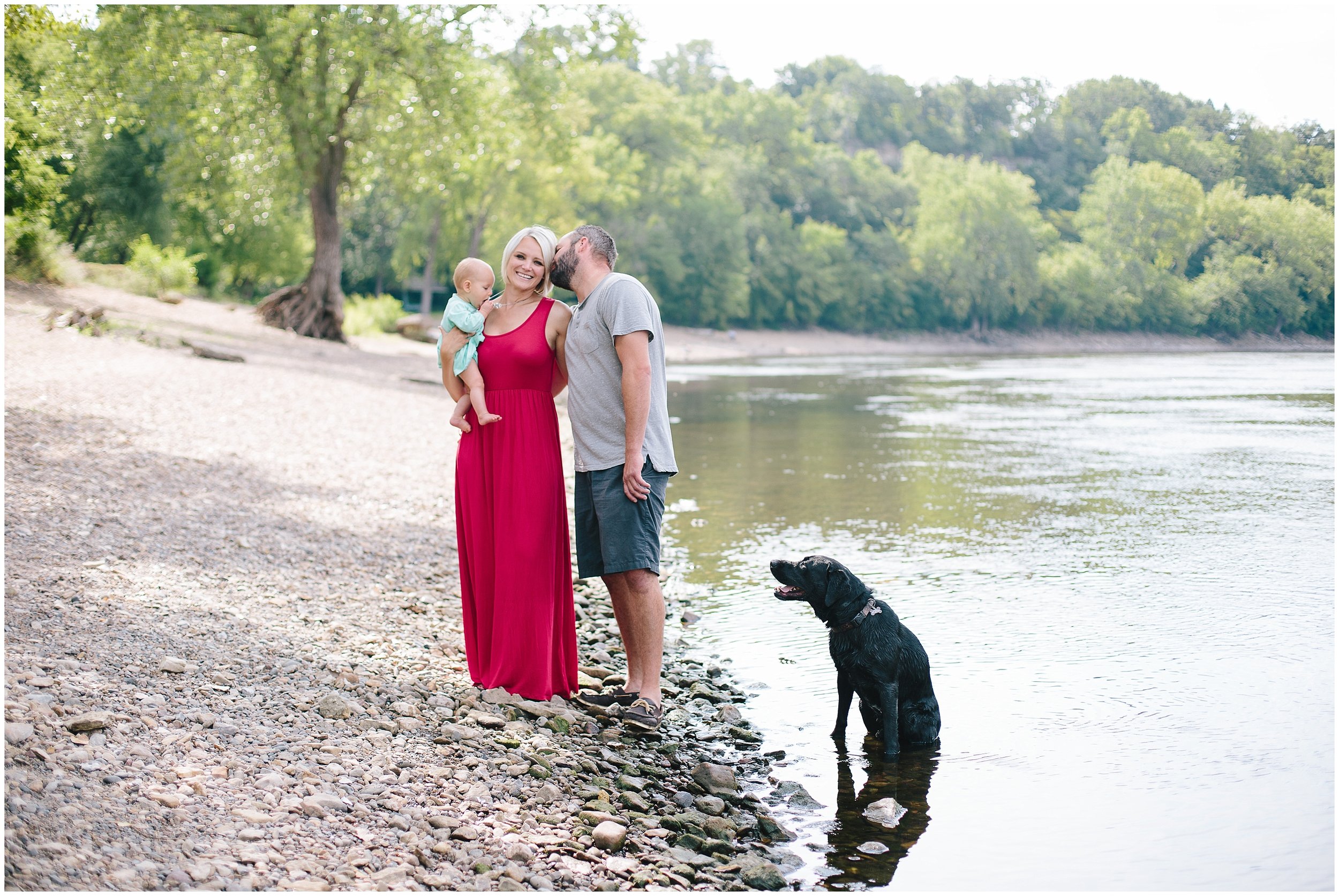 Family kisses at the river at Hidden Falls Regional Park