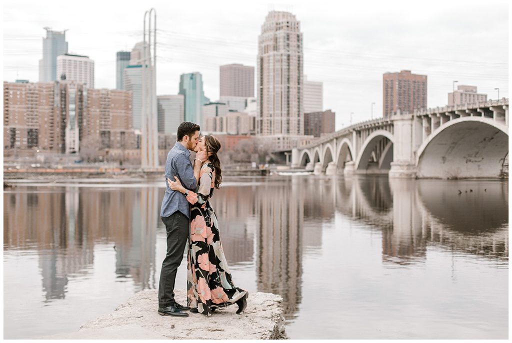 Engaged couple with Minneapolis skyline in background