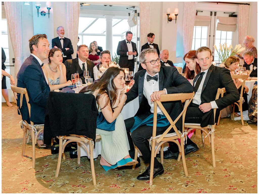 Guests listening to toasts at wedding reception