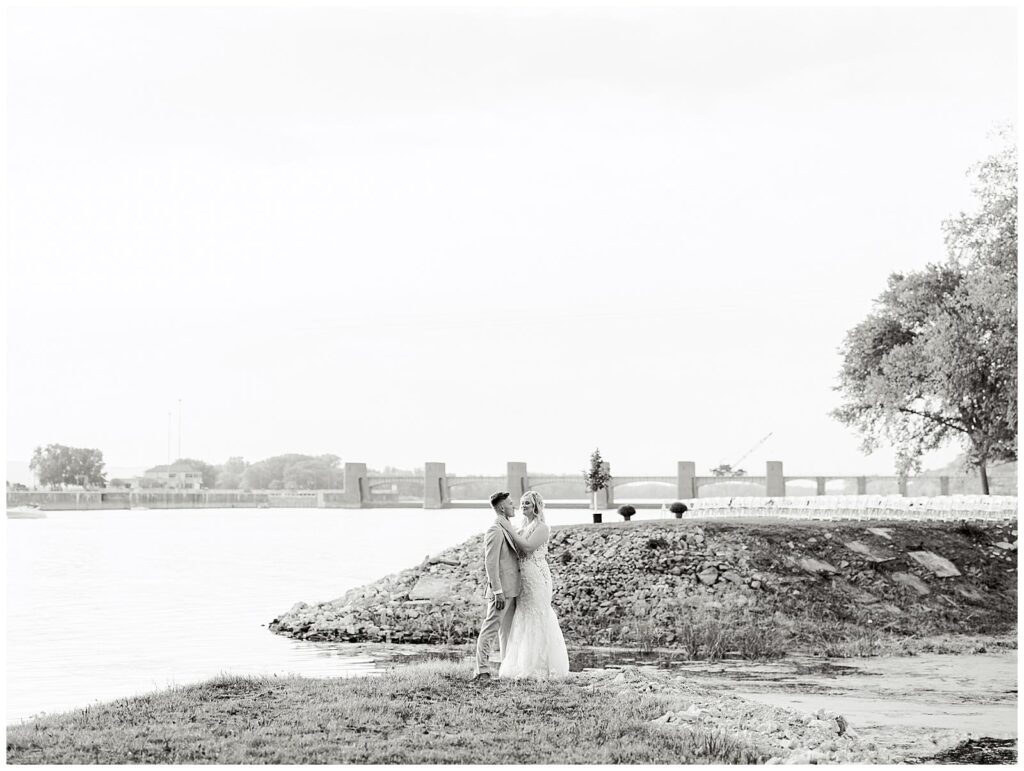 Couple portrait overlooking the Mississippi River during their tented Wisconsin wedding reception.