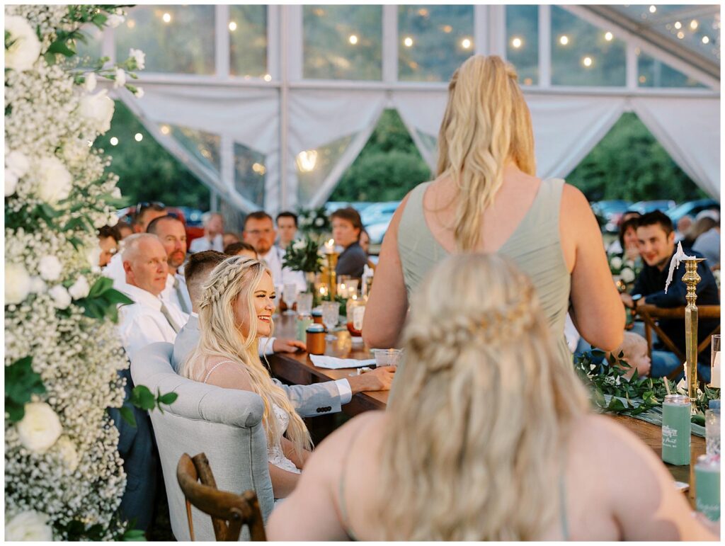 Maid of honor gives a toast at a tented Wisconsin wedding reception.