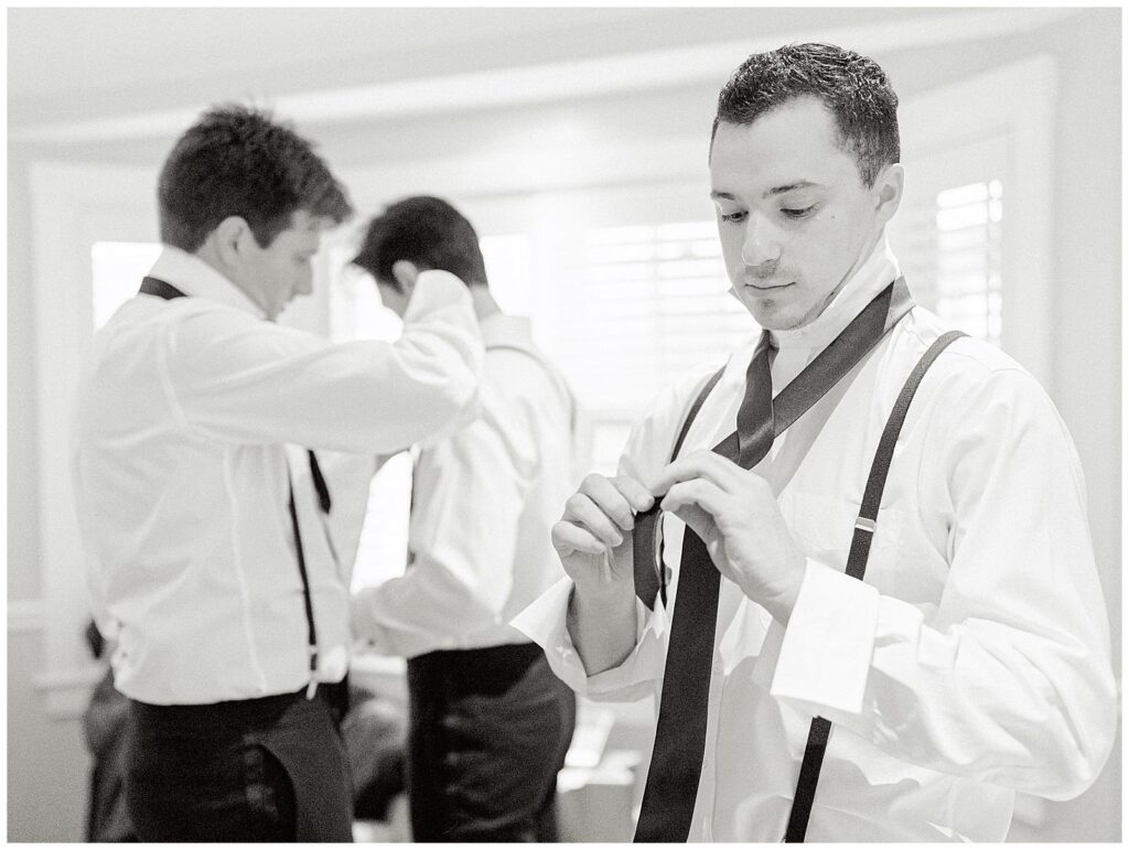 Groomsmen tie their ties as they get ready for the Chatham Bars Inn wedding.