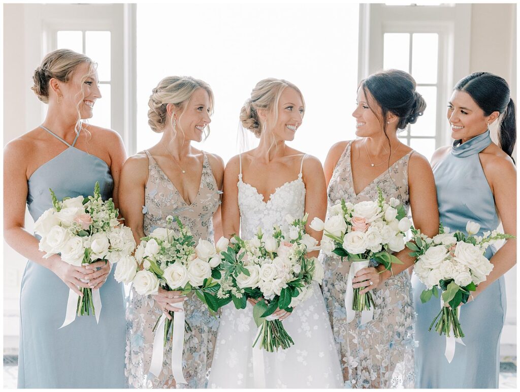 The bride and bridesmaids smile at each other at Chatham Bars Inn.