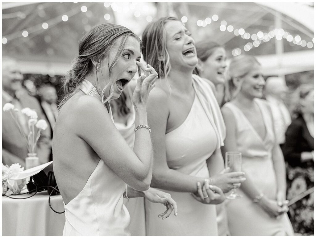 Bridesmaids tear up during father of the bride toast.